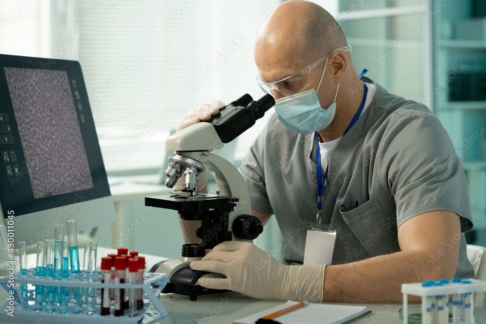 Aufkleber laboratory expert checking sample under microscope