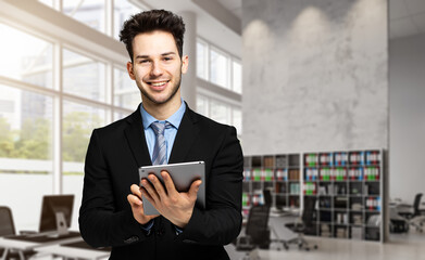 Young manager using a digital tablet in his office