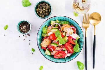 Traditional italian tomato salad panzanella with mozzarella, capers, red onion and croutons. Summer salad. Tuscan salad. Top view, above, copy space