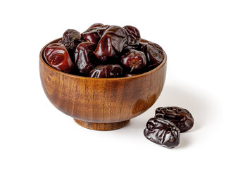 Sweet dried dates in a wooden bowl isolated on white background. Delicious vegetarian, dieting and high-calorie healthy food ingredient. Ready to eat natural fruits and berries. Organic Iranian dates.