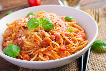 Spaghetti alla Amatriciana with guanciale, tomatoes and pecorino cheese. Italian healthy food.