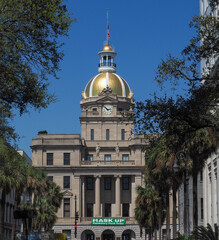 Beautiful downtown Savannah building with golden dome has a huge sign attached directing people to "Mask Up - Mandatory Mask Order" to help combat Covid-19