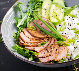 Homemade baked sliced beef and rice bowl with salad. Diet menu.