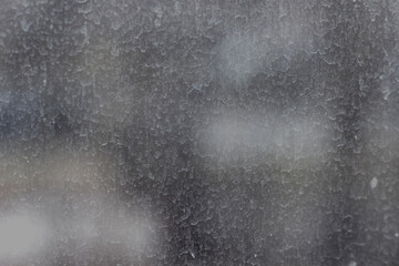 Streaks and traces of raindrops on the dirty window glass. Blurry and unfocused background. - obrazy, fototapety, plakaty