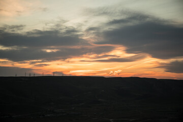 Obraz premium Colorful sunset over the mountain hills. Beautiful clouds flying over the lake near mountains. Evening time shot over the clouds. Baku, Azerbaijan.