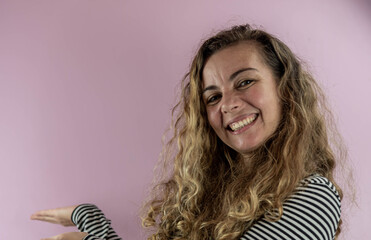 Facial expression of Brazilian woman on pink background.