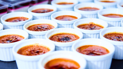 Rows of Creme brulee. Traditional French vanilla cream dessert with caramelised sugar on top. Shallow dof