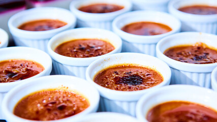 Rows of Creme brulee. Traditional French vanilla cream dessert with caramelised sugar on top. Shallow dof