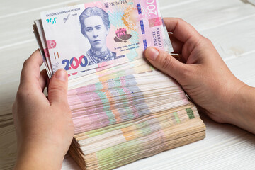 Stack of ukrainian hryvnia banknotes in hands