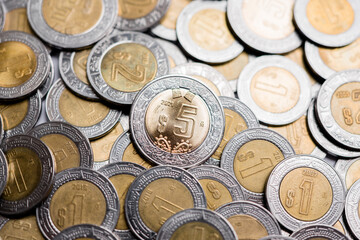 Mexico City, Mexico »; April 24 2021: Coin of five pesos of 2021, to the center of more coins.