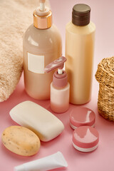 Skin care products on pink background, nobody