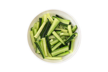 Sliced cucumber in a plate on a white background. Fresh cucumber sliced into pieces close-up.