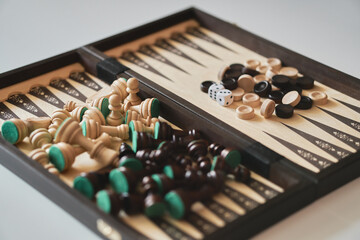 Game set checkers chess backgammon. When the board is unfolded, checkers and pieces are visible in a heap.