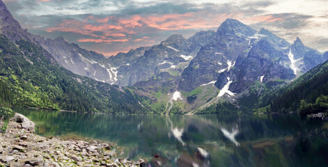 Wide angle shot of Misty and rainy view of mountain landscape, beautiful day with dramatic sky in Morskie Oko, Zakopane located in south Poland.