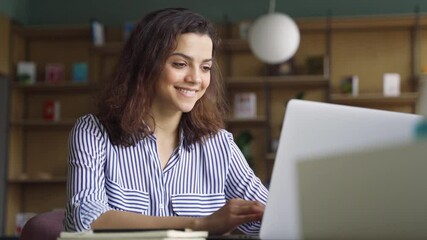 Happy latin girl college student using laptop computer watching distance learning seminar class, remote university webinar or having virtual classroom meeting, studying online in university campus. - Powered by Adobe