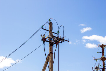High-voltage concrete pillar against the blue sky