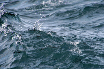 Close up of wavy lake water with splash droplets