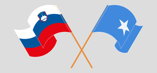 Crossed and waving flags of Slovenia and Somalia