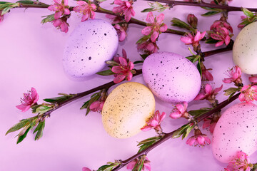 Colorful Easter eggs with pink flowers of the spring garden. Festival of colored eggs. Easter