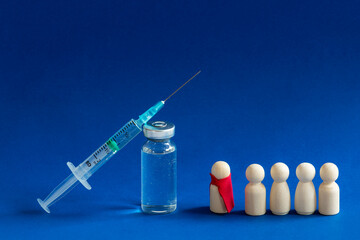 Human vaccination concept. Vaccine covid 19 and wooden man with red clothes. 