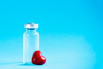 Vaccine vial and red heart. Safe vaccination concept