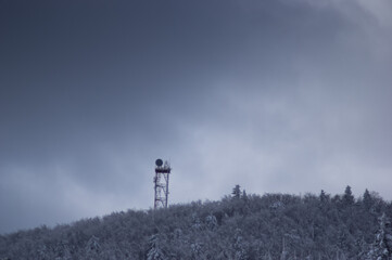 Transmitting tower in the forest in winter