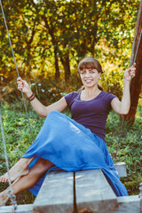 beautiful girl sitting on a swing
