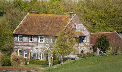 Fototapeta na wymiar a secluded traditional English stone farmhouse nestled amongst the valleys on the Southern edge of Pewsey Vale, Wiltshire AONB 