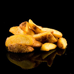 Potato wedges on black background