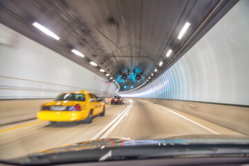 Taxi speeding up along Miami tunnel, blurred fast motion