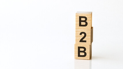 b2b - acronym from wooden blocks with letters, business to business. White background.