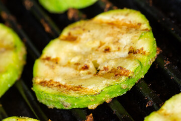 Grilled zucchini slice prepared on a grill. Close-up.