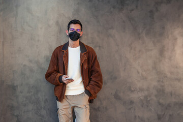 man with mask and mobile phone