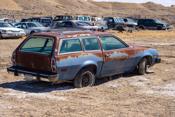 An old retro junked car from a junkyard.