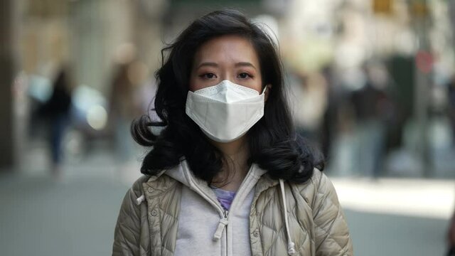 Asian Woman In City Wearing A Mask During Covid 19 Pandemic In New York City Face Portrait