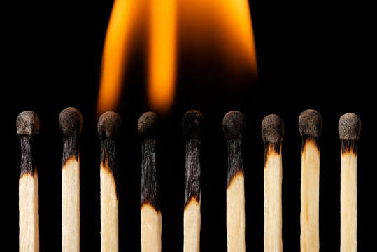 Matches on fire, black background, horizontal shot. Concept of burnout, nervous devastation of a team.