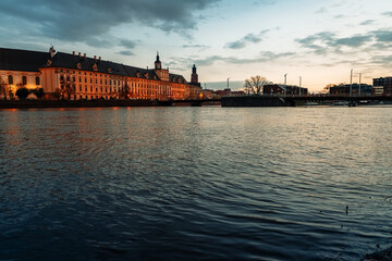 Fototapeta premium sunset over the oder river and view of the old town of wroclaw in poland