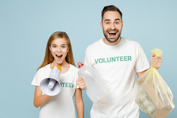 Two friends couple teen girl man wears white t-shirt green title volunteer hold bag trash scream megaphone isolated on pastel blue color background Voluntary free team work help charity grace concept