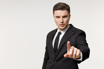 Young strict employee business corporate lawyer man 20s in classic formal black grey suit shirt tie work in office point index finger camera on you do it isolated on white background studio portrait.