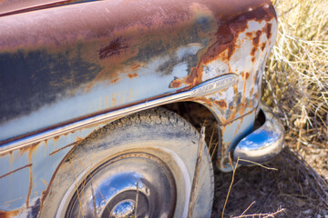 Detail shot of junked retro vintage vehicle in a junkyard.