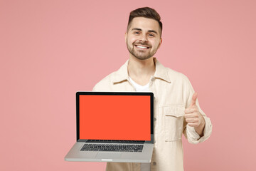 Young copywriter happy freelancer man 20s wearing jacket white t-shirt using laptop pc computer...