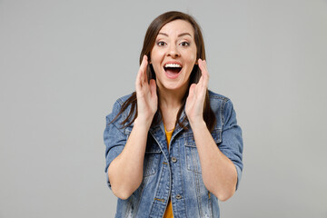 Young expressive excited caucasian woman 20s wearing casual denim jacket yellow t-shirt scream news...