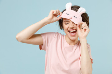 Young fun happy caucasian woman 20s wear pajamas jam sleep rest relaxing at home took off blindfold...