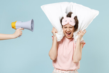 Young woman in pajamas jam sleep eye mask rest relax home look aside sad tired woman cover ear...