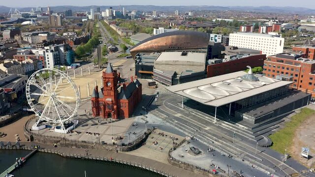 Aerial view climbing over the Welsh Senydd and Cardiff Bay, Wales