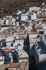 View across white village in mountains of the Sierra Nevada, Las Alpujarras, Granada Province, Spain