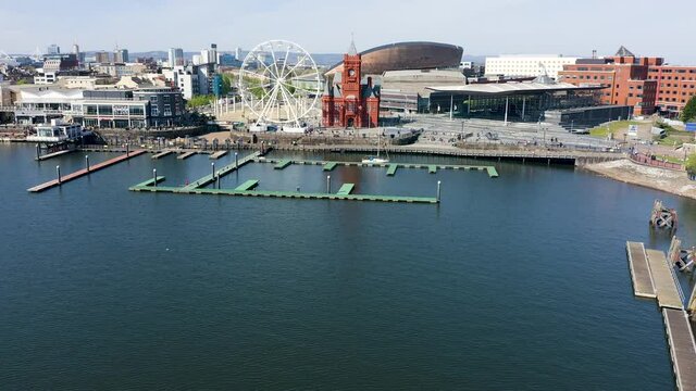 Low aerial view flying towards the landmarks of Cardiff Bay