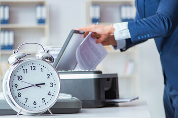 Businessman making copies in copying machine