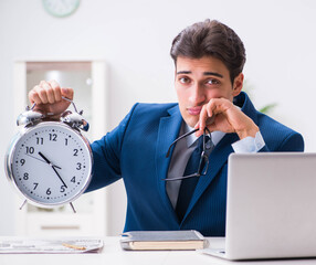 Businessman employee in urgency and deadline concept with alarm
