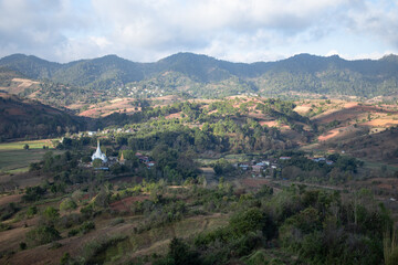 A white pagoda by rolling hills between Kalaw and Inle Lake